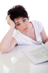 lady looking stressed as she is reading